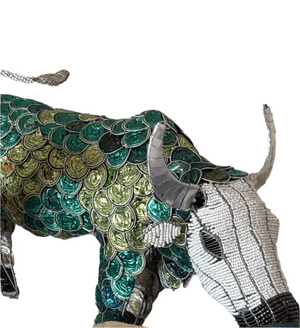 This image features a unique piece of art, a sculpture of a buffalo crafted from coffee pods. The artist has meticulously used green and blue coffee pods to create the body and pattern detailing on the buffalo, while the head and horns are made from metal, adding a contrasting element.